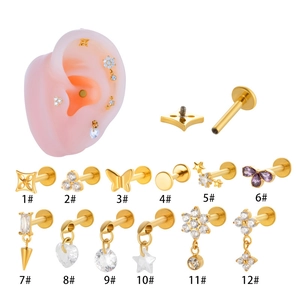 Detailed views of gold titanium stud earrings with zircons in flower and star shapes