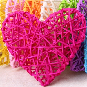 Close-up of a pink heart-shaped rattan decoration showing intricate woven textures