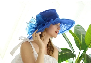 Detail of blue organza sun hat featuring an elegant oversized floral side decoration