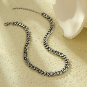 Detail view of silver Cuban link necklace with lobster clasp and extension chain