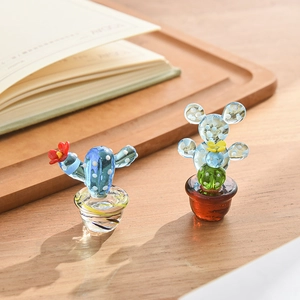 Handcrafted decorative glass cactus figurines set on wooden table for home decor