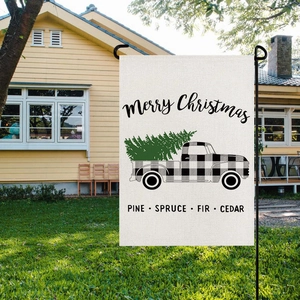 Outdoor view of Christmas garden flag with vintage truck design on linen fabric