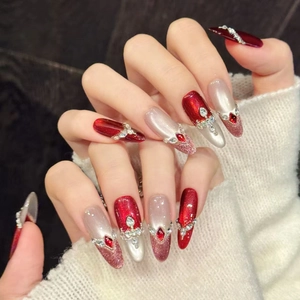 Luxurious red cat eye press-on nails with rhinestones and almond shape design