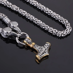 Detailed shot of two-tone Mjolnir pendant with Byzantine chain and dragon head clasps