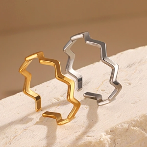 Minimalist 18K gold and silver wave rings on white stone for a luxury look