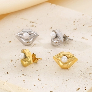 Detail of lip-shaped gold and silver earrings featuring central pearl inlays on stone