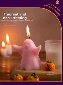 Detail view of pink ghost candle with pumpkin decor for Halloween room decoration