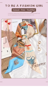 Detail of vintage French silk scarf with orange stripes and elegant metal ring buckle