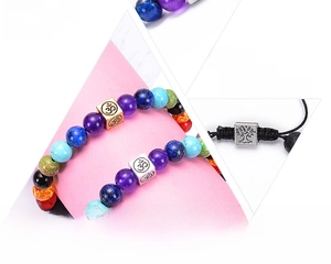 Detail of 8mm seven chakra natural lava stone yoga bracelets with Om and Tree of Life charms