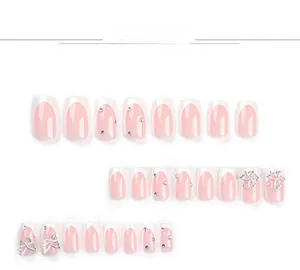 Detailed set of French tip press-on nails with silver 3D butterflies and sparkling rhinestones