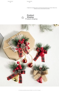 Detail of Christmas hanging ornaments with pine needles, cones, bows and metal bells