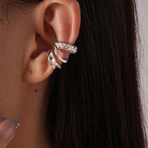 Three-piece set of silver metallic irregular geometric ear cuffs worn on model ear