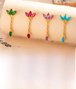 Detail showing four sets of stainless steel cartilage studs with colorful zircon stones