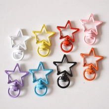Star-shaped colorful alloy snap hooks in eight vibrant shades displayed on grey surface