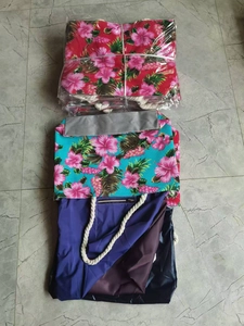 Flat lay of floral canvas tote bag with thick rope handles and tropical hibiscus print