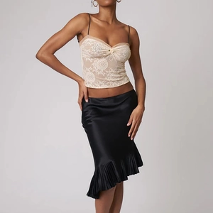 Women's black satin pleated midi skirt with chic beige lace bodice top outfit view