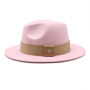 Pink wool fedora hat detail featuring khaki grosgrain band and gold bee emblem
