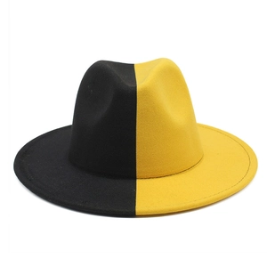 Détail du chapeau fedora en feutre bicolore noir et jaune avec bord large