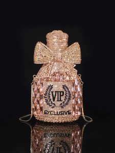 Macro shot of luxury champagne bottle clutch with sparkling crystals and VIP engraving