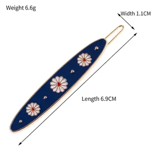 Elegant navy blue daisy hair clip with gold alloy finish and floral pattern