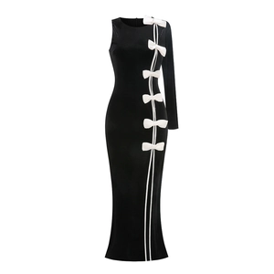 Detail of velvet dress with white bows and asymmetrical one-shoulder design