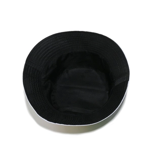 Detail of a black cotton bucket hat showing reinforced brim stitching and interior lining