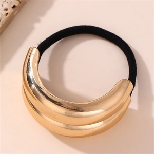 Detail of minimalist gold metal cross design hair tie with black elastic band