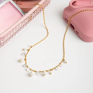Detail of 18K gold stainless steel necklace with white pearls and cubic zirconia stones