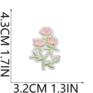 Detail view of pink flower embroidery patch with size labels 4.3cm by 3.2cm