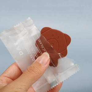 Close-up of bear-shaped compressed facial sponge with frosted individual packaging