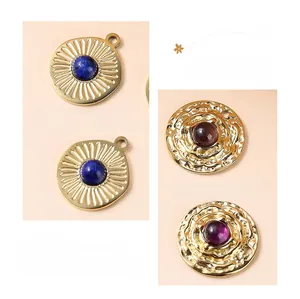 Detail of sunburst and hammered gold pendants with natural lapis lazuli and amethyst