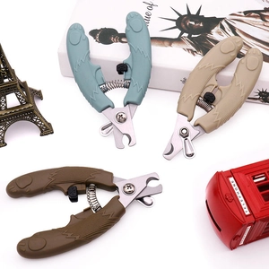 Detail view of stainless steel pet nail clipper with safe blade and non-slip grip