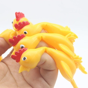 Macro shot of yellow rubber slingshot chicken toy showing its soft squeeze texture