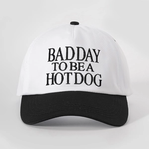 Detail of high-quality embroidery text on a black and white cotton baseball cap