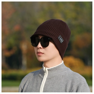 Detail of FARDI leather patch on men's thick coffee-colored knitted winter earflap hat