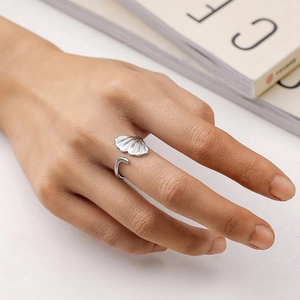 Detailed close-up of a silver ginkgo leaf open ring showing fine metallic textures