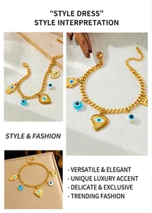 Macro detail of golden stainless steel chain bracelet with evil eye and heart charms