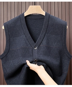 Close-up of dark blue V-neck knit vest texture and button details on thick fabric