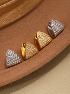 Detail of triangle stud earrings in gold and silver finish with pavé set cubic zirconia