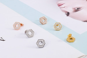 Detailed view of hexagonal stud earrings set with rhinestones in gold, silver, and rose gold