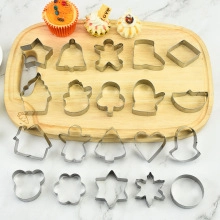 Macro detail of various stainless steel cookie cutter shapes on a wooden board