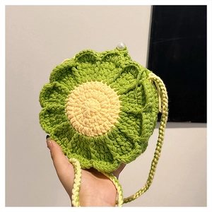 Close-up of green flower crochet bag featuring 3D petals and a white pearl button