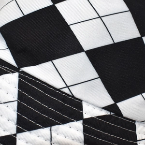 Macro shot of black and white checkerboard fabric texture and durable double stitching
