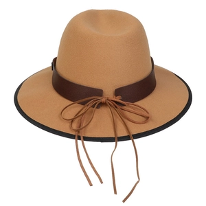 Close-up of camel felt fedora hat featuring a brown leather band and intricate tie detail