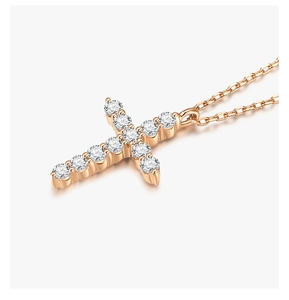 Detail of rose gold cross necklace featuring sparkling pave-set cubic zirconia crystals