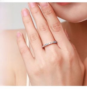 Detail of sterling silver eternity ring with colorful micro-paved rainbow gemstones
