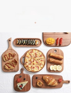 Top view of assorted natural ebony wood serving boards and mini cutting blocks