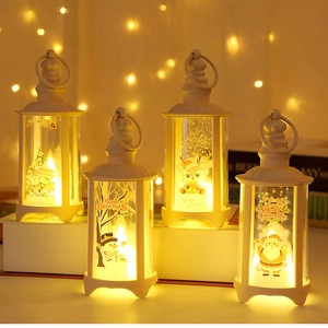 Detail of four white Christmas LED lanterns with festive Santa and reindeer patterns