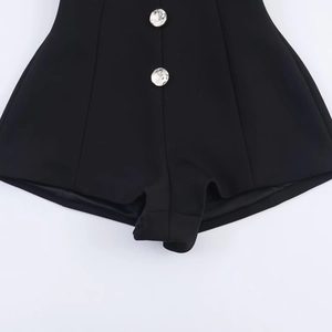 Black high-waisted shorts featuring two large vertical rhinestone buttons on high quality fabric