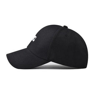 Detailed side view of black cotton NYC baseball cap featuring white letter embroidery